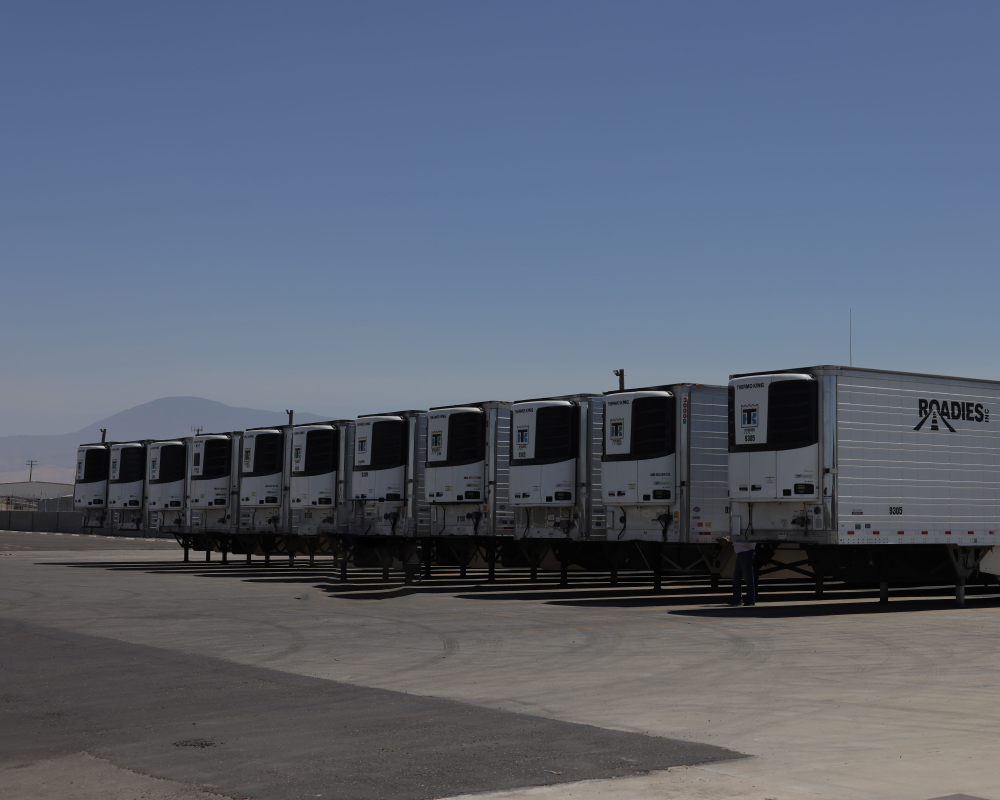 Truck with drop trailer being loaded at a warehouse for freight shipping
